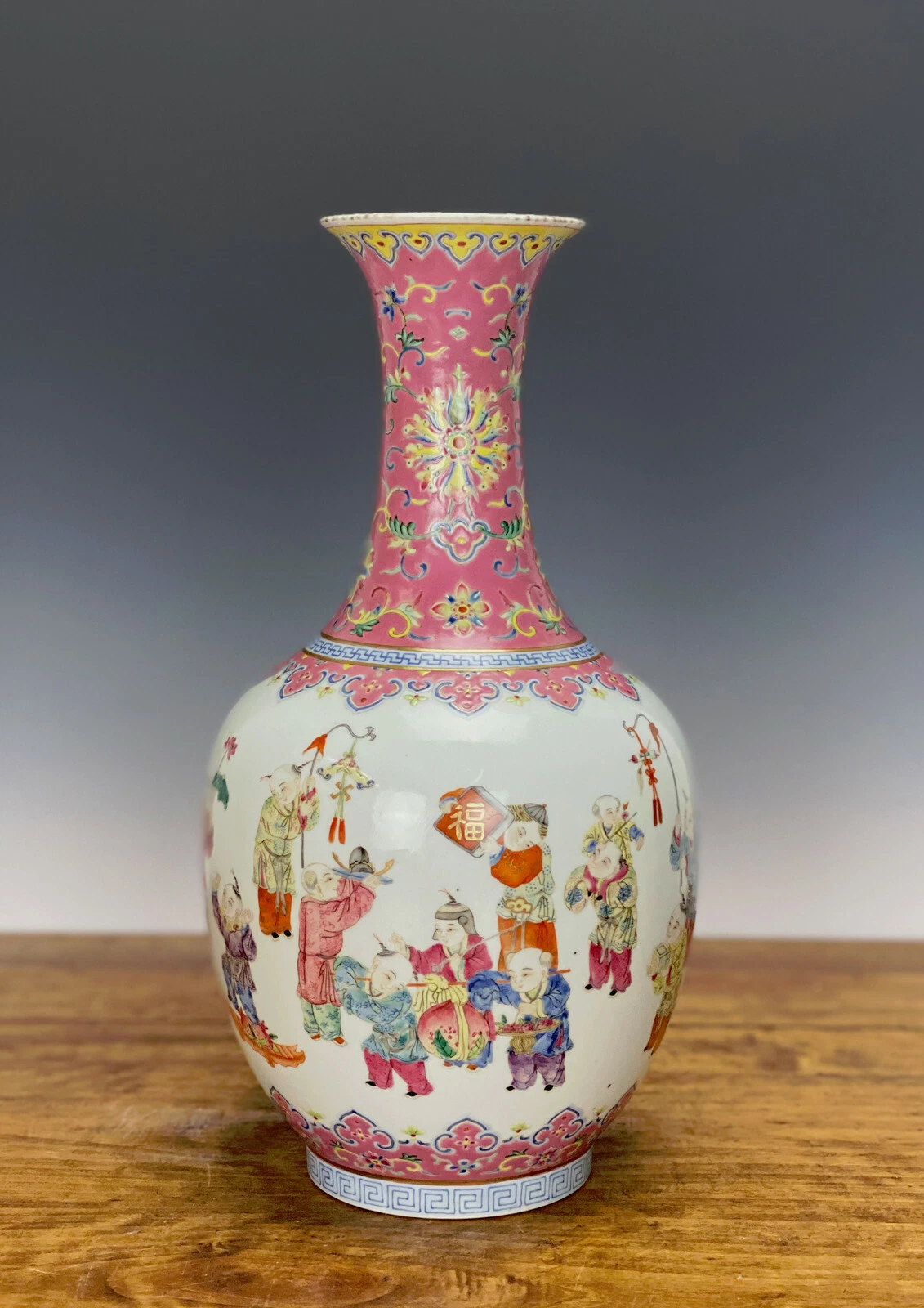 Chinese Famille Rose 'Hundred Children' Baluster Vase, bearing a Qianlong Mark