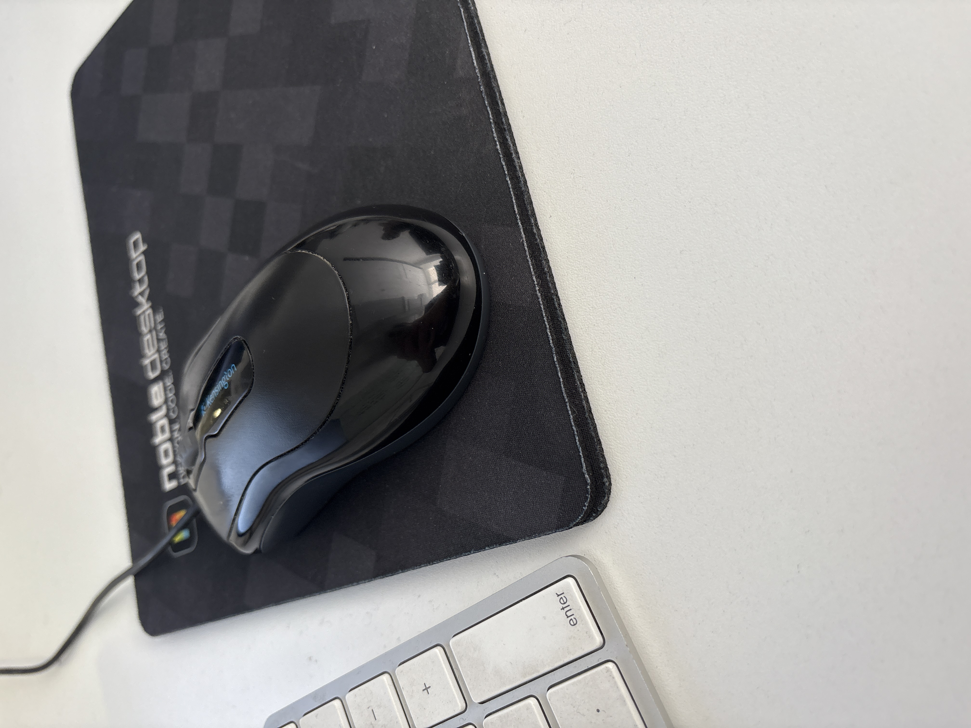 Modern Wired Computer Mouse on Branded Mouse Pad